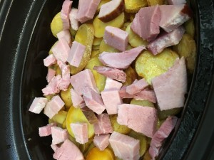 Layering Potatoes and Ham into the crock pot